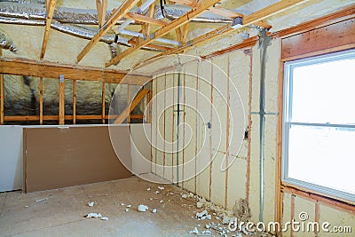 Insulation of attic with foam polyurea insulation cold barrier and insulation material Stock Photo