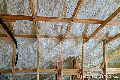 Insulation of attic with foam polyurea insulation cold barrier and insulation material Stock Photo