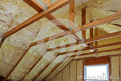 Insulation of attic with foam polyurea insulation cold barrier and insulation material Stock Photo