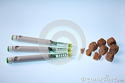 Insulin in syringe pens against brown sugar. Diabetes treatment concept Stock Photo