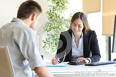 Insurance agent and customer calculating budget Stock Photo