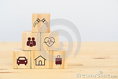 Insurance concept, wooden cube symbolize put the insurance to protect or cover person, Property ,Liability, reliability,car, life, Stock Photo