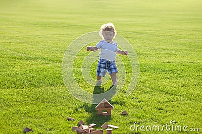 Insurance kids. Happy childhood. Little baby learning to crawl steps on the grass. Concept childrens months. Happy child Stock Photo