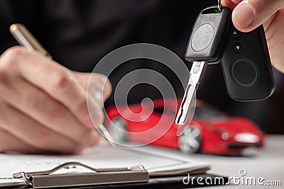 Insurance officers hand over the car keys after the tenant Stock Photo