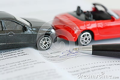 Insurance policy contract concept with toy model cars having a crash Stock Photo