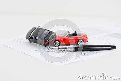 Insurance policy contract concept with toy model cars having a crash Stock Photo