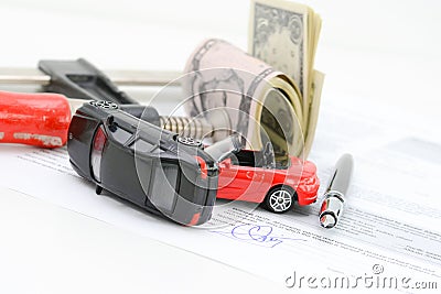 Insurance policy contract concept with toy model cars having a crash Stock Photo