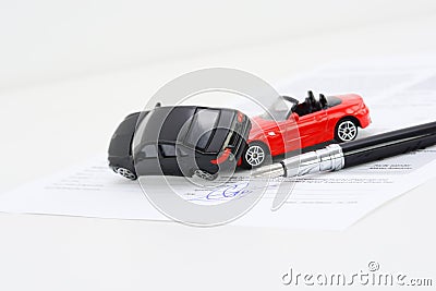 Insurance policy contract concept with toy model cars having a crash Stock Photo