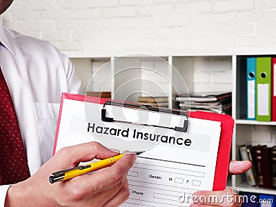 Insurer shows Hazard insurance form for signing. Stock Photo