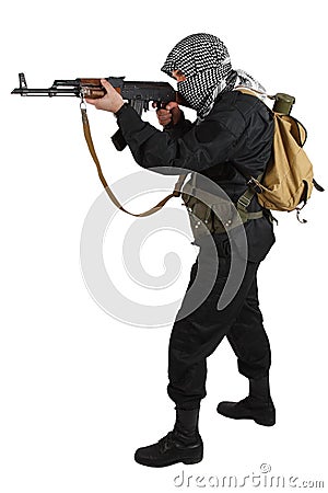 Insurgent dressed in black uniform and black and white shemagh with AK 47 rifle Stock Photo