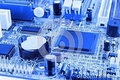 Integrated semiconductor microchip microprocessor on blue circuit board representative of the high tech industry and computer scie Stock Photo