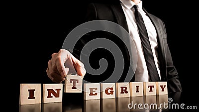 Integrity on Wooden Piece Arranged by Businessman Stock Photo