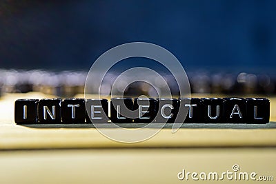 INTELECTUAL concept wooden blocks on the table. Stock Photo