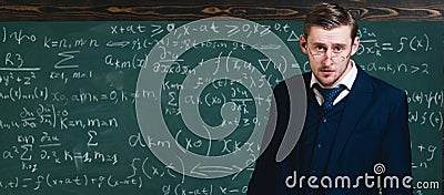 Intelligent teacher in suit and glasses. Young professor explaining mathematic formula. Stock Photo