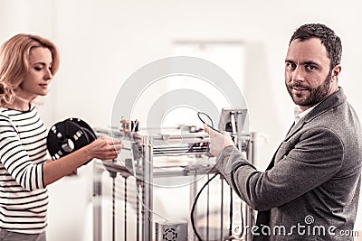 Intelligent technicians fixing and adjusting office equipment Stock Photo