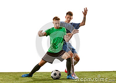 Two soccer players in action, motion on green grass flooring isolated over white background. Concept of global sport Stock Photo