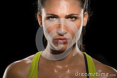 Intense stare eyes determined athlete champion glare head shot sweaty confident woman female powerful fighter close up Stock Photo