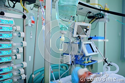 Intensive care unir with patient in the bed conected to the life rescue equipment Stock Photo
