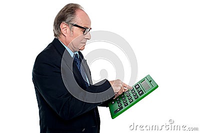 Intent looking executive working on a calculator Stock Photo