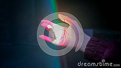 Woman moving hand under colorful laser rays - close up view - visuals concept Stock Photo