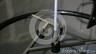 Magnetic pendulum moves between three magnets Editorial Stock Photo