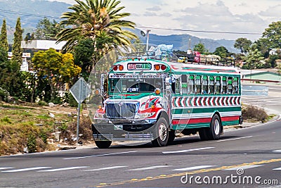 INTERAMERICANA, GUATEMALA - MARCH 22, 2016: Colourful chicken bus, former US school bus, rides on Interamericana highway Editorial Stock Photo