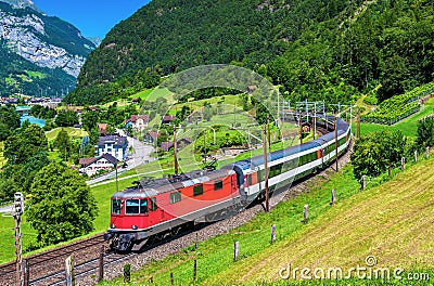 Intercity train climbs up the Gotthard railway - Switzerland Stock Photo