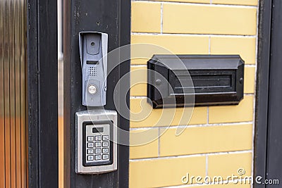 intercom panel with a video camera on the brick fence of private house Stock Photo