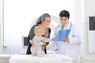 Interested baby on examination of pediatric doctor Stock Photo