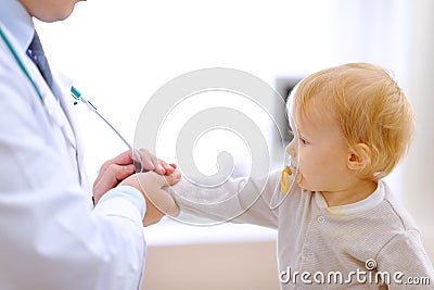 Interested baby stretching for stethoscope Stock Photo