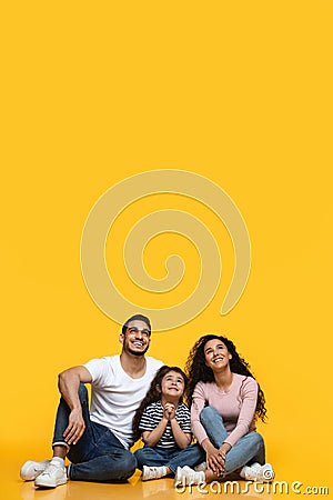 Interesting Offer. Smiling Middle-Eastern Family Of Three Looking Up At Copy Space Stock Photo
