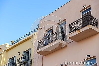 Interesting photo of old lady standing on balcony of old building. Editorial Stock Photo
