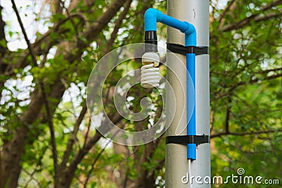 An interesting solution to repairing a high and unreachable, broken, Thai park light pole, using simple materials. Stock Photo