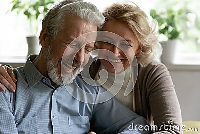 Happy retired family couple embracing spending time for pleasant conversation Stock Photo