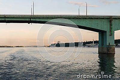 Yaroslavl, Russia, July 8, 2023. View of the river and embankment at sunset through the bridge truss. Editorial Stock Photo