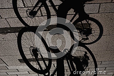 Interesting view of a man riding a bicycle and his shadow Stock Photo