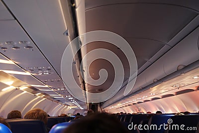 Interior of airplane with passengers on seats waiting to taik of Editorial Stock Photo