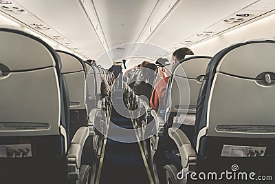 Interior of airplane with passengers on seats waiting to taik off. Stock Photo