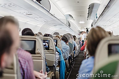 Interior of airplane with passengers on seats waiting to taik off. Stock Photo