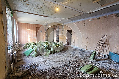 Interior of apartment during on the renovation and construction. Garbage and waste from dismantling in bags for disposal Stock Photo