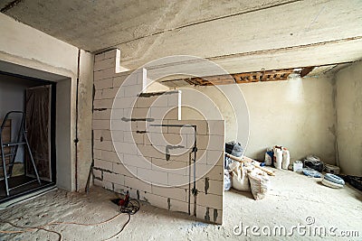 Interior of an apartment room with bare walls and ceiling under construction Stock Photo