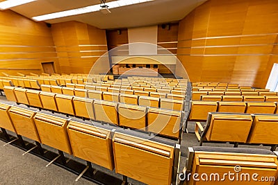 Interior of big conference hall full of gray folding chairs Stock Photo