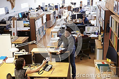 Interior Of Busy Architect's Office With Staff Working Stock Photo