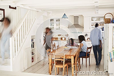 Interior Of Busy Family Home With Blurred Figures Stock Photo