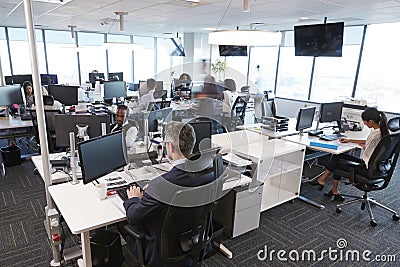 Interior Of Busy Modern Open Plan Office With Staff Stock Photo