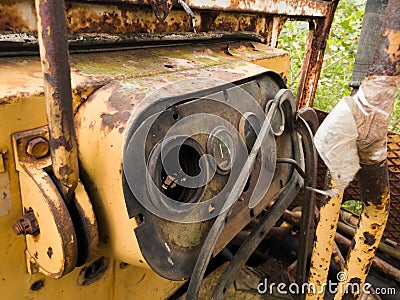 Interior of cabin with levers and instruments panel of abandoned deserted old rusty bulldozer, vintage industrial heavy machine, Stock Photo
