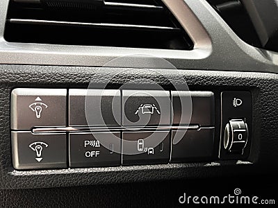 The interior of the car. Buttons for adjusting the height of the headlights, turning off the ESP, distance, dead zone Stock Photo