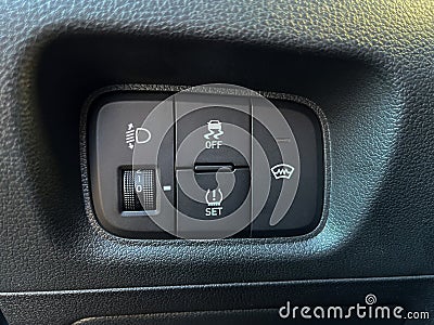 The interior of the car. Buttons for adjusting the height of the headlights, turning off the ESP, turning on the windshield heatin Stock Photo