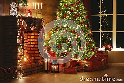 Interior christmas. magic glowing tree, fireplace, gifts in dark Stock Photo