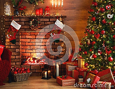 Interior christmas. magic glowing tree, fireplace, gifts in dark Stock Photo